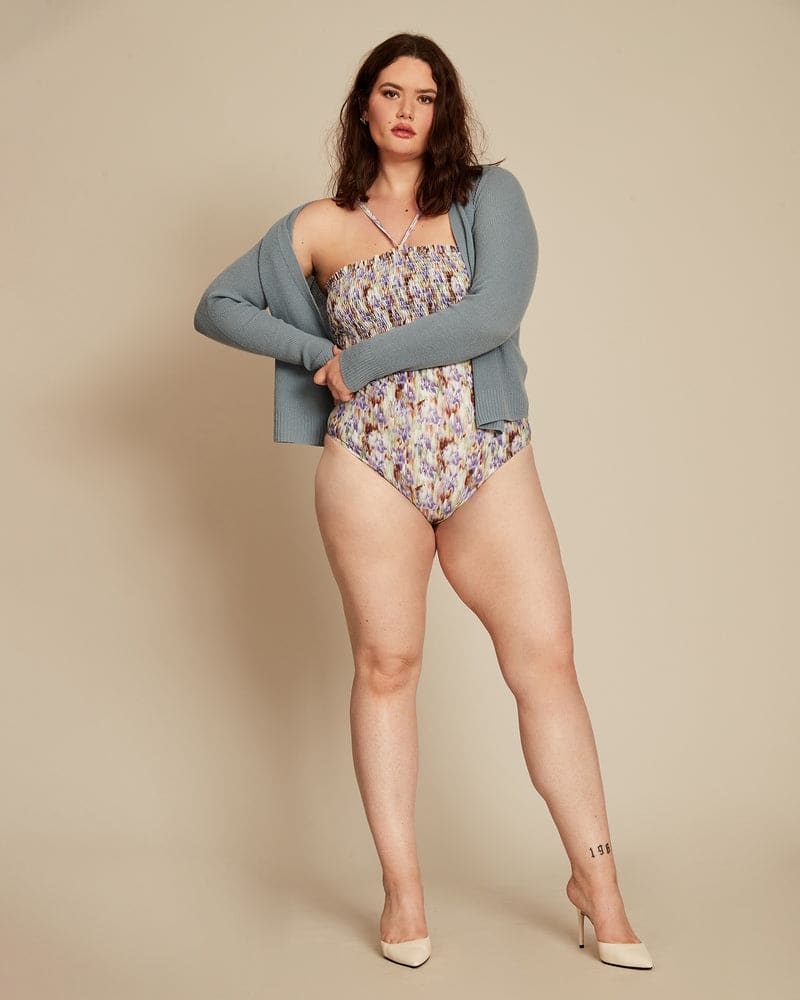 Front of a model wearing a size 2X Kendra Smocked One Piece in Purple by Tanya Taylor. | dia_product_style_image_id:230226